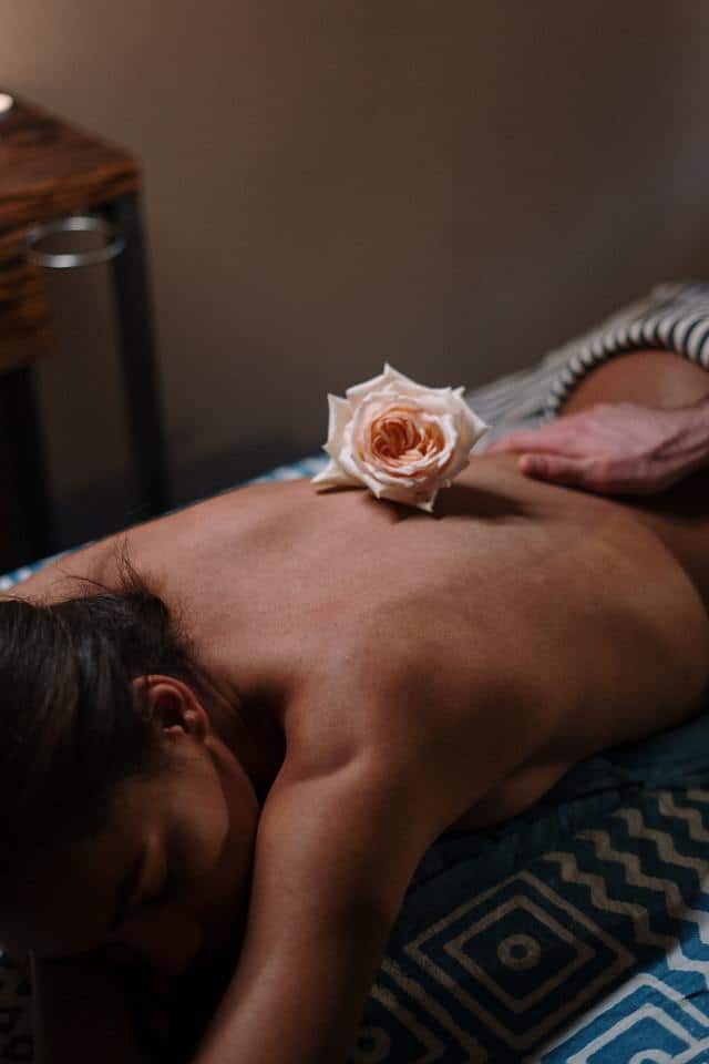 Massage Rose Essential Oil On Lower Back to Balance Sacral Chakra