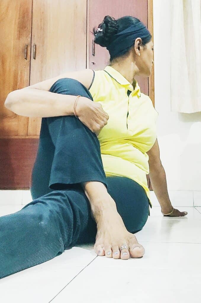 Vakrasana - spinal twist is a yoga pose that helps with constipation during pregnancy 